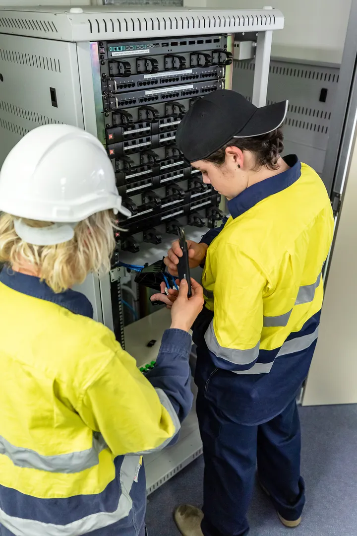 Technicians working on a server rack.