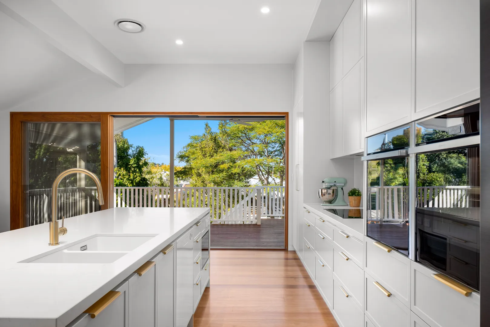 Modern kitchen with island, large windows, and outdoor view