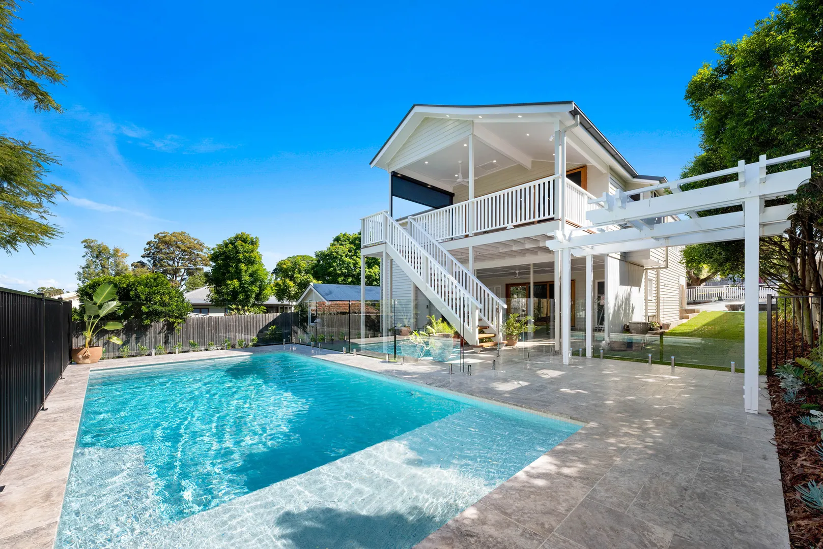 Modern two-story home with backyard pool and patio.