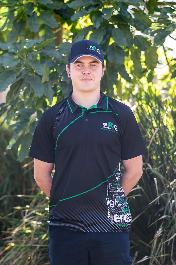 E.R.C. Electrical Services employee in branded uniform outdoors.
